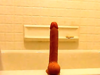 solo crossdresser playing with a dildo